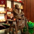 Tượng Tôn giả Mục Kiền Liên ngồi trên ghế đẩu bằng đồng hun nâu